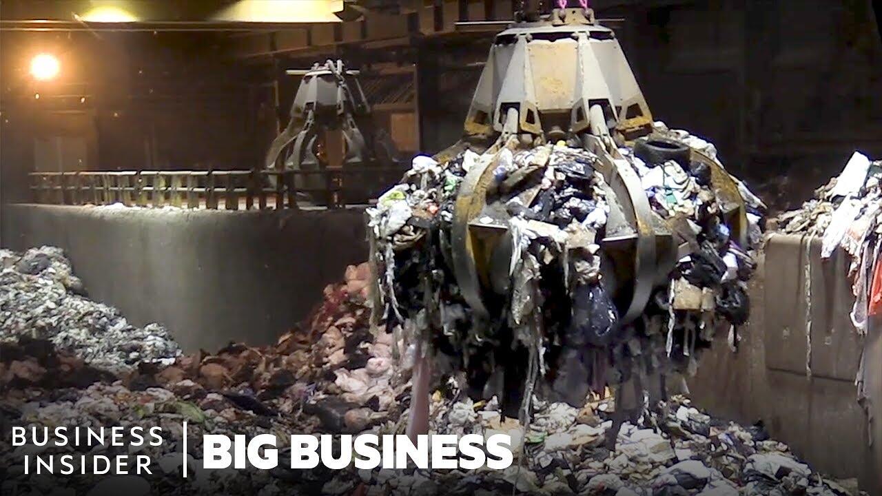 A transfer station floor piled with municipal trash